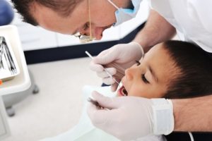 little kid at dentist getting cavity treated