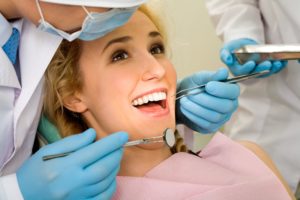 dentist examining teen's wisdom teeth